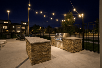 Outdoor kitchen with builtin grill and string lights